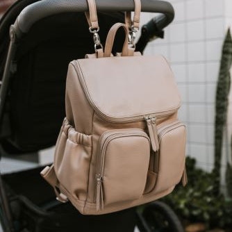 Nappy backpack oat dimple hanging on the back of the pram