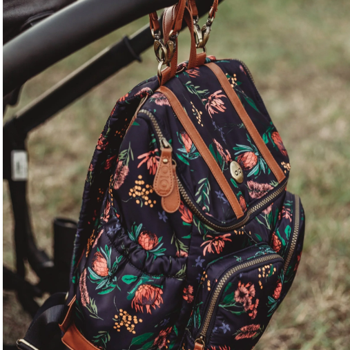 Nappy Backpack in Floral hanging on a pram