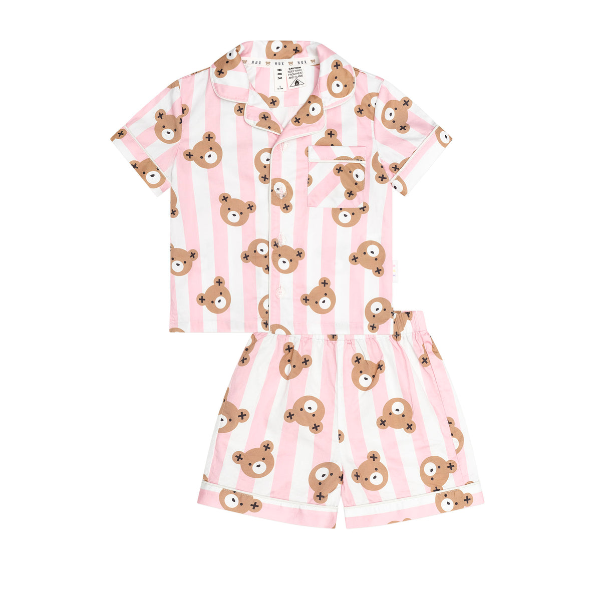 A two-piece children's pajama set featuring a short-sleeve button-up shirt and matching shorts, both with pink and white vertical stripes and an all-over print of brown teddy bear faces, shown on a plain white background.