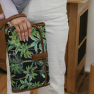 Mum holding a change mat clutch in tropical black