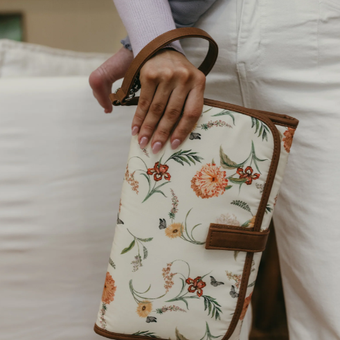 Mum holding a change mat clutch
