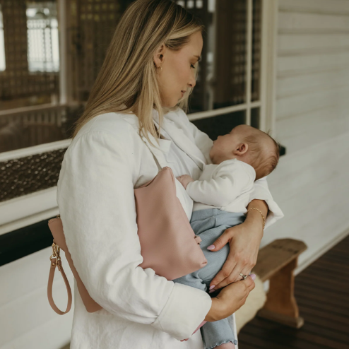 Mum carrying a nappy pouch and baby