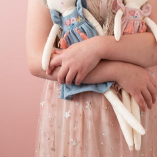 Miss Lily Blue Doll being cuddled by a girl