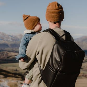 Dad wearing the multitasker backpack in black