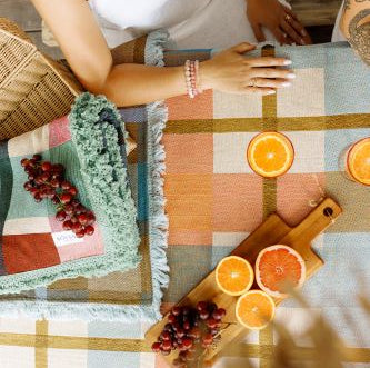 People using the solsse picnic rug throw as a table cloth