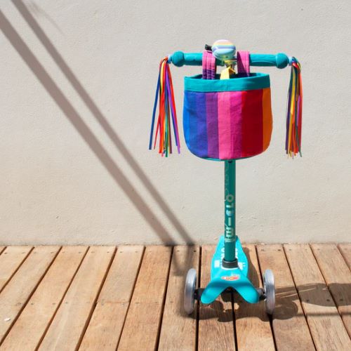 Beep Rainbow streamers on a scooter