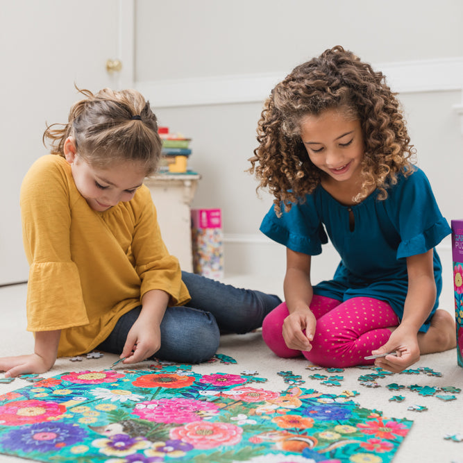Two girls playing with the secret garden puzzle