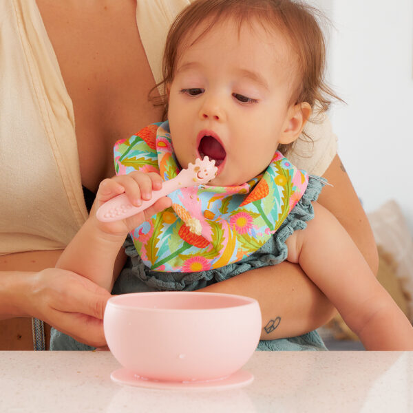 Baby using suction silicone bowl and mini spoon