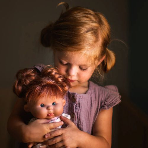 Little girl holding a baby doll pepote special funtastic