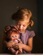 Little girl holding a baby doll pepote special funtastic