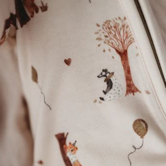 Close up of bamboo zipsuit in autumn bear print