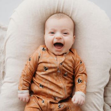 baby wearing bamboo zipsuit in bumble bee print