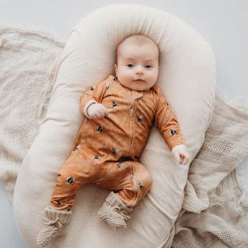 Baby wearing bamboo zipsuit in bumble bee print
