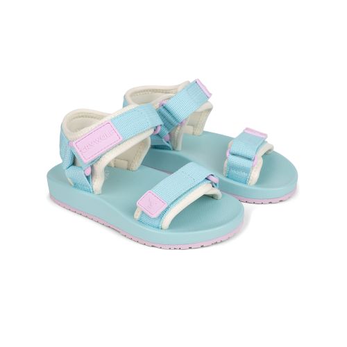 A pair of toddler sandals in light blue with white fleece lining and pastel pink accents, including adjustable straps and a matching pink outsole, shown on a white background.