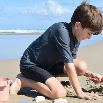 Boy playing with the beach set on the beach