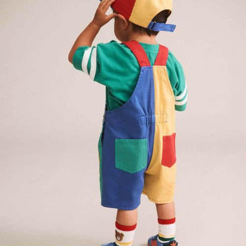 the back of a boy wearing colour block pocket shortall