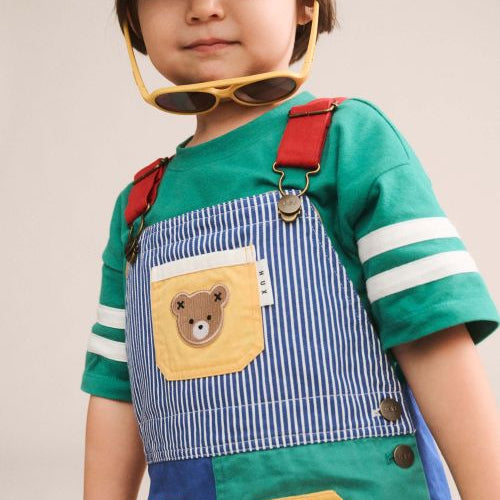 Boy wearing colour block pocket shortall