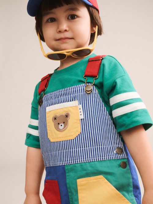 Boy wearing colour block pocket shortall