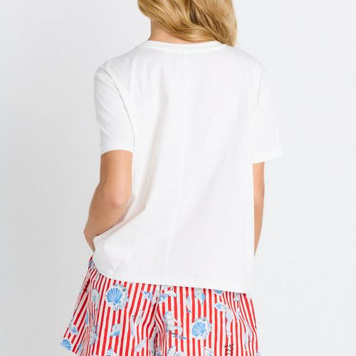 A woman shown from the back wearing a white short-sleeve t-shirt and red-and-white striped shorts with a blue seashell pattern, against a plain white background.