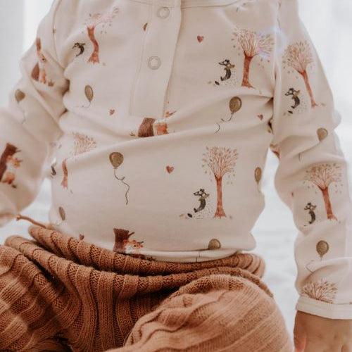Toddler wearing Henley bodysuit in autumn bear print