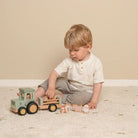 kid play with little farm tractor trailer
