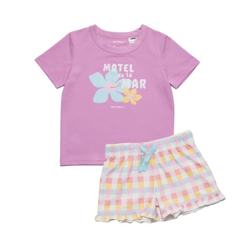 A toddler girl's two-piece pajama set from Cotte Valley, featuring a lavender short-sleeve t-shirt with a colorful floral graphic and the French text 'MATEL de LA GAR' printed on the front, paired with pastel pink, yellow, and blue gingham check shorts with a ruffled hem and a light blue bow at the waist.