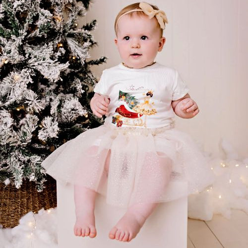 Baby wearing the sparkly gold tulle skirt