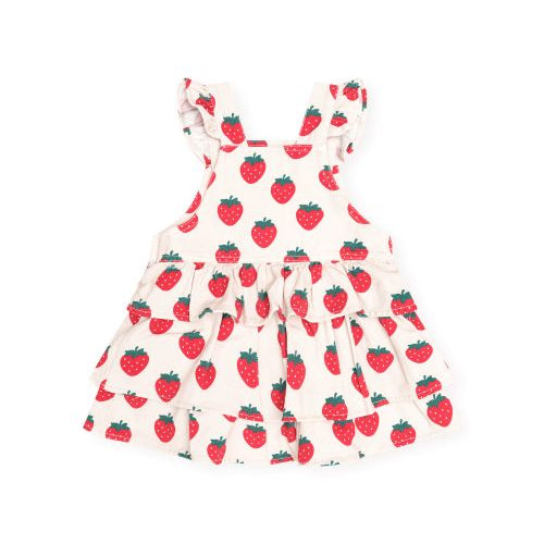 A white tiered baby dress with ruffled shoulder straps, featuring an all-over red strawberry print with green leaves, shown against a plain white background.