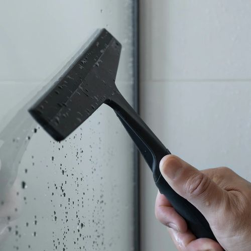 shower squeegee being used on glass
