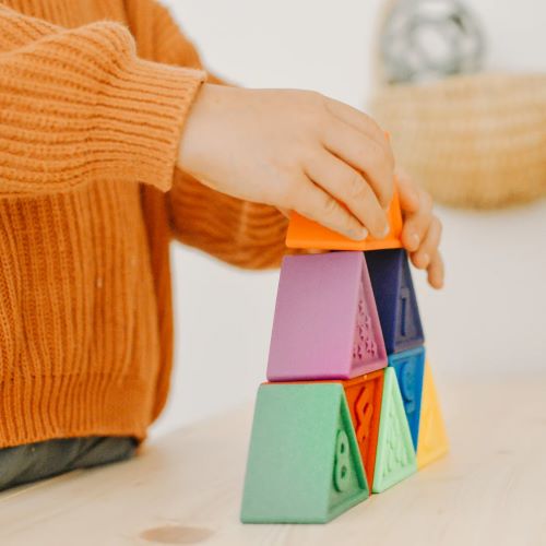 Child building with Triblox rainbow bright