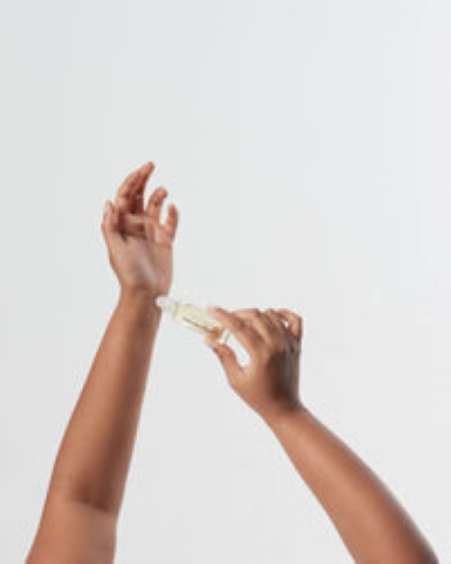 Person using the aphrodite perfume roller