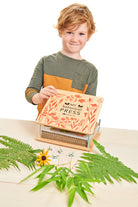 Boy using the botanical flower press