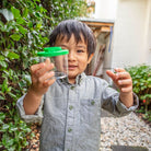 Boy catching bugs with the bug spotter kit