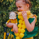 Little Girl playing with Cora Corn Happy Harvest Doll