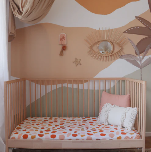 Cot sheet on a cot in a nursery earthy terrazzo