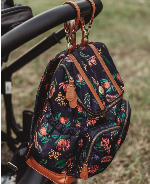 Nappy Backpack in Floral hanging on a pram