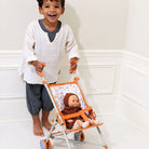 Boy pushing the forest doll umbrella stroller