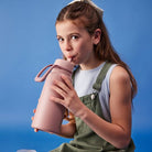 girl using b.box fliptop bottle in color berry smoothie