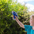 Child playing with galaxy water blaster