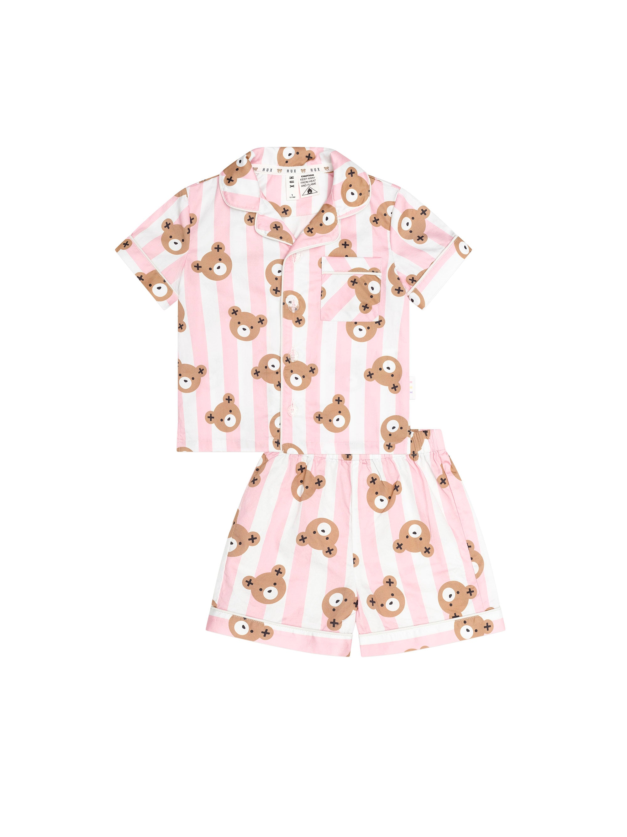 A two-piece children's pajama set featuring a short-sleeve button-up shirt and matching shorts, both with pink and white vertical stripes and an all-over print of brown teddy bear faces, shown on a plain white background.