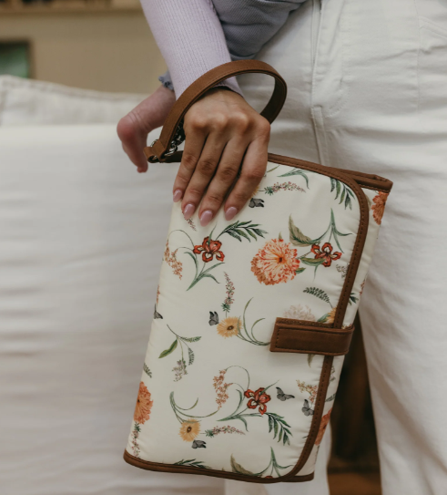 Mum holding a change mat clutch