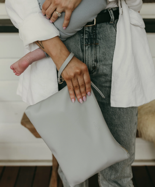 Mum holding the nappy pouch in blue