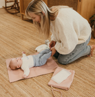 Mum using the nappy pouch changing a baby