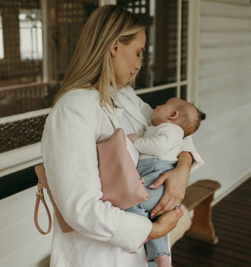 Mum carrying a nappy pouch and baby