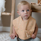 Toddler wearing lemon snuggle bib