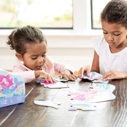 Two girls playing with puzzle 