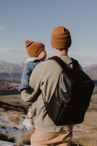 Dad wearing the multitasker backpack in black