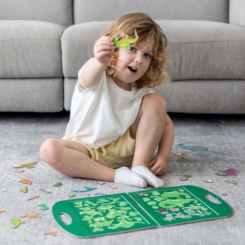 Child playing with magna carry dinosaurs