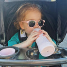 toddler using subo food bottle 