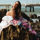 Beach pic of lady enjoying the solsse the label luxury picnic rug/throw Nella